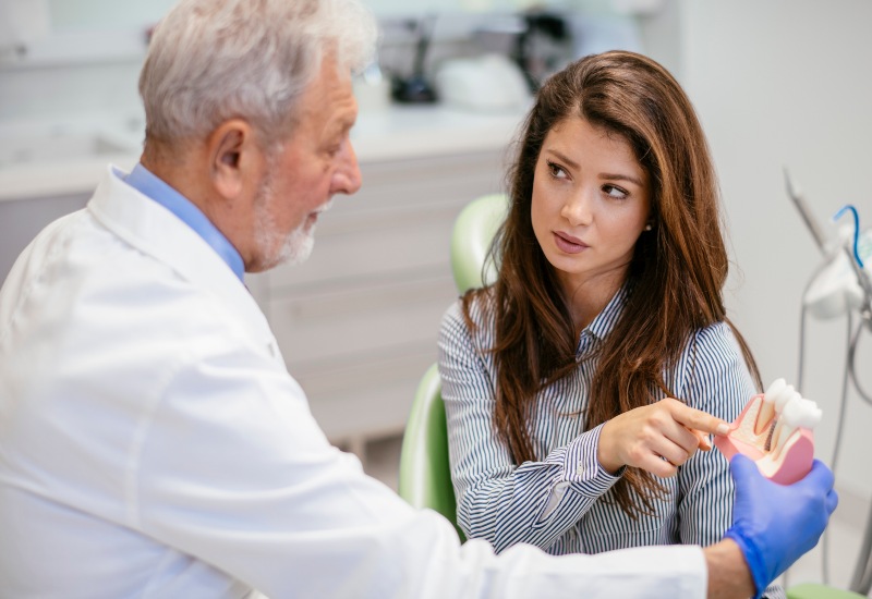 A patient consulting with a dentist about dental implants in a dental clinic in St. Louis, MO